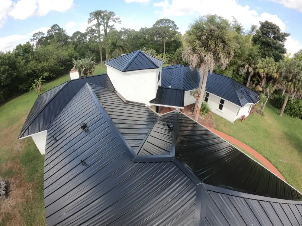 Aerial view of roofing contractor work showcasing high-quality metal roof replacement