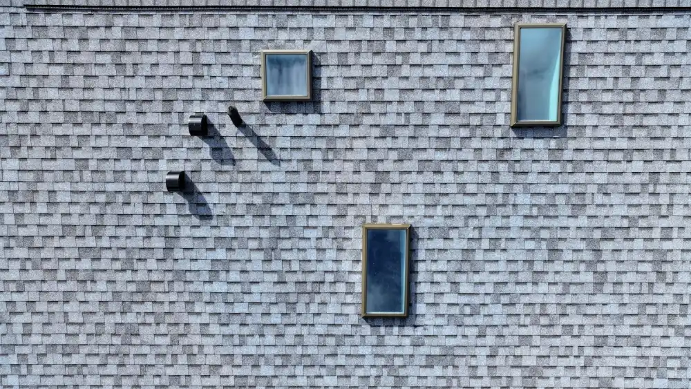 Asphalt roof with multiple skylights and black roof vents